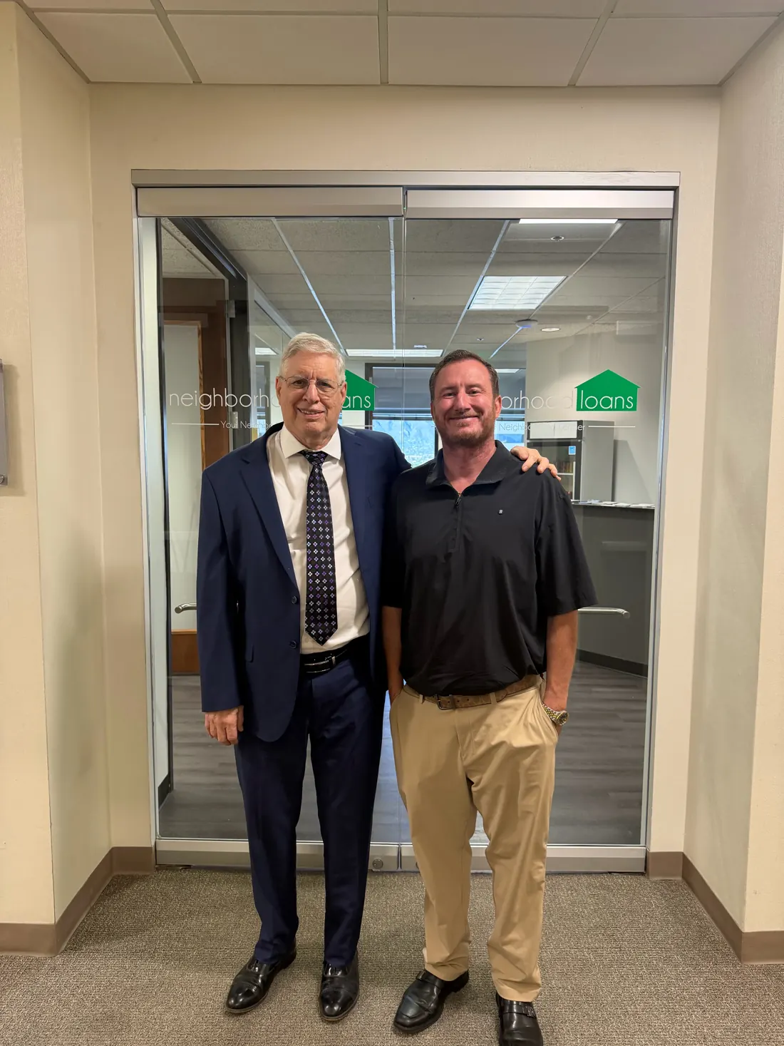 Andy Braun and his dad Kevin Braun at the Neighborhood Loans office door in Tucson